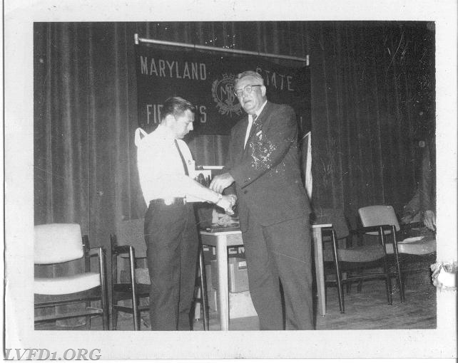 1970: George Duke is presented the &quot;George W. Colburn Award at the MSFA convention in Ocean City for a rescue operation involving an unconscious subject at the bottom of a well on Tudor Hall Farm presented by Mitch Boulden, Past President, MSFA